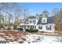 Two-story house with brick and white siding, porch, and landscaping. Winter scene at 380 River Point Dr, Mcdonough, GA 30252