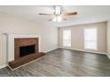 Living room with fireplace, hardwood floors, and ceiling fan at 380 River Point Dr, Mcdonough, GA 30252