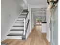 Bright entryway with gray stairs and light hardwood floors at 1102 Hip Pocket Rd, Peachtree City, GA 30269