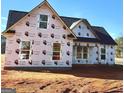 New home construction featuring windows and wrap, showcasing modern building techniques at 123 Oak Road, Locust Grove, GA 30248
