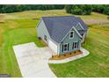 Desirable single-Gathering home with green siding and a concrete driveway and attached garage at 123 Oak Road, Locust Grove, GA 30248