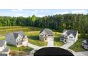 Beautiful aerial view of new homes in a cul-de-sac near a wooded area and pond at 13232 Tolstoy Drive, Covington, GA 30014
