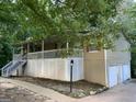 Home exterior featuring a charming porch, stairs, and two-car garage at 3746 Chapel Hill Road, Douglasville, GA 30135