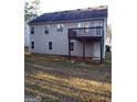 Home's back view, showcasing a deck and backyard at 3590 Stephens Creek Pl, Loganville, GA 30052