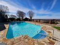 Stone-surround pool with a scenic view at 1909 Hickory Level Rd, Villa Rica, GA 30180