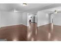 Open concept living area with hardwood floors and view into kitchen at 215 Elliott Rd, Mcdonough, GA 30252