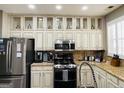This kitchen features granite counters, stainless steel appliances and custom white cabinets at 144 Cottsford Sw Dr # 22, South Fulton, GA 30331