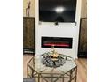 Modern living room featuring a sleek fireplace and glass coffee table at 144 Cottsford Sw Dr # 22, South Fulton, GA 30331