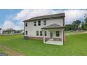 Beautiful backyard featuring a covered patio and spacious lawn at 376 Collier Mills Road, Lawrenceville, GA 30045