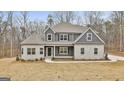 Two-story house with gray siding and stone accents at 214 Wet Wood Ct # 26, Fairburn, GA 30213