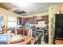 Kitchen with dark brown cabinets and stainless steel appliances at 1826 E Farris Ave, East Point, GA 30344
