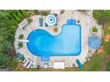 Aerial view of kidney-shaped pool with lounge chairs at 324 Chimney Sweep Cir, Peachtree City, GA 30269