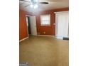 Bright bedroom with orange walls and tile flooring at 6796 Black Twig Ct, Riverdale, GA 30274