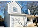 Attached garage with white door and gray siding at 5496 Orchard Ct, Stone Mountain, GA 30083