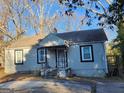 Charming single-story home featuring a covered porch, classic windows, and a compact deck at 4692 College St, Forest Park, GA 30297