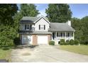 Charming two-story home featuring a two-car garage, brick accents, and a cozy front porch at 3013 Pommel Ct, Conyers, GA 30013