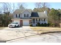Two-story house with attached garage and covered porch at 3013 Pommel Ct, Conyers, GA 30013