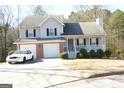Two-story house with attached garage and covered porch at 3013 Pommel Ct, Conyers, GA 30013
