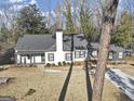 Stylish home with a striking roofline and manicured lawn, blending modern design with natural surroundings at 1571 Boulevard Lorraine Sw, Atlanta, GA 30311