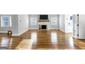 Bright living room with beautiful wood floors and a cozy fireplace, perfect for relaxing and entertaining at 1571 Boulevard Lorraine Sw, Atlanta, GA 30311
