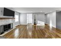 Inviting living room with hardwood floors, neutral walls, and a cozy fireplace for comfortable living at 1571 Boulevard Lorraine Sw, Atlanta, GA 30311