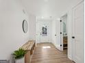 Bright entryway with a wood bench, decorative mirror, and view to the front door at 3939 Hamilton Mill Rd, Buford, GA 30519