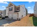 View of home's side and backyard featuring a large driveway and a well-maintained lawn at 151 Brasch Park Dr, Grantville, GA 30220