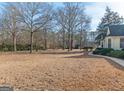 Spacious backyard with mature trees and a grassy lawn at 130 Seneca Pl, Fayetteville, GA 30215