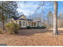 Yellow house with wrap around porch and large backyard at 130 Seneca Pl, Fayetteville, GA 30215