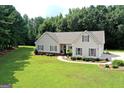 Aerial view showcasing the house's setting on a spacious lot with lush landscaping at 2204 Happy Hollow Se Ct, Conyers, GA 30094