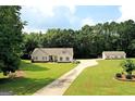 House and detached garage viewed from above, showing ample yard space and driveway at 2204 Happy Hollow Se Ct, Conyers, GA 30094