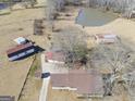 Aerial view of property showing house, pond and multiple outbuildings at 444 Agape Rd, Carrollton, GA 30116