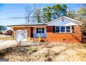 Brick ranch house with attached garage and mature trees at 653 Temple St, Lithia Springs, GA 30122