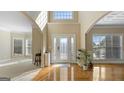Inviting foyer boasts hardwood floors, soaring ceilings, and a decorative glass front door at 301 Dunstans Pass, Marietta, GA 30066