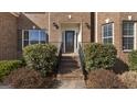 Charming brick home featuring a front door with glass accents and landscaped front yard at 301 Dunstans Pass, Marietta, GA 30066