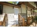 Exterior of home featuring a covered porch with a white front door and stone foundation at 60 Sweet Bay Ln, Carrollton, GA 30116