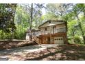 Attractive split-level home with stone accents, front porch, and lush surrounding trees at 60 Sweet Bay Ln, Carrollton, GA 30116
