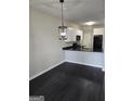 Modern kitchen with white cabinets, granite counters, and black appliances at 4328 Barcelona Trce, Stone Mountain, GA 30083