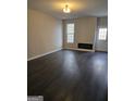Spacious living room with dark hardwood floors and fireplace at 4328 Barcelona Trce, Stone Mountain, GA 30083