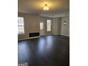 Open living area with dark hardwood floors and fireplace at 4328 Barcelona Trce, Stone Mountain, GA 30083