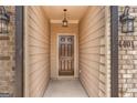 Front entry of townhome with brown door and light-colored walls at 4121 Fulson Dr, Lilburn, GA 30047