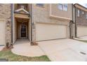 Front view of townhome with covered entry and attached garage at 4121 Fulson Dr, Lilburn, GA 30047