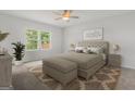 Inviting bedroom showcasing a queen-sized bed, soft lighting, and a serene atmosphere at 214 Kindness Cir, Mcdonough, GA 30252