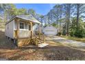 Detached guest house with wooden steps and a large yard at 10 Oxford Pl, Sharpsburg, GA 30277