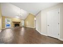 Living room with a stone fireplace and vaulted ceilings at 10 Oxford Pl, Sharpsburg, GA 30277