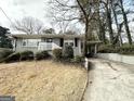 Ranch home with a driveway and mature trees at 1931 Sandringham Sw Dr, Atlanta, GA 30311