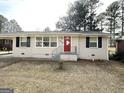 Charming ranch home with a red front door and landscaped yard at 2284 Headland Dr, East Point, GA 30344