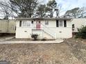 Newly painted Ranch home with red front door and steps at 490 Woods Dr, Atlanta, GA 30318