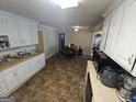Galley style kitchen with white cabinets at 1617 Corona Dr, Austell, GA 30168