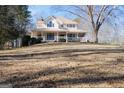 House on a hill with large yard and surrounding trees at 1885 Jenny Ln, Lithia Springs, GA 30122
